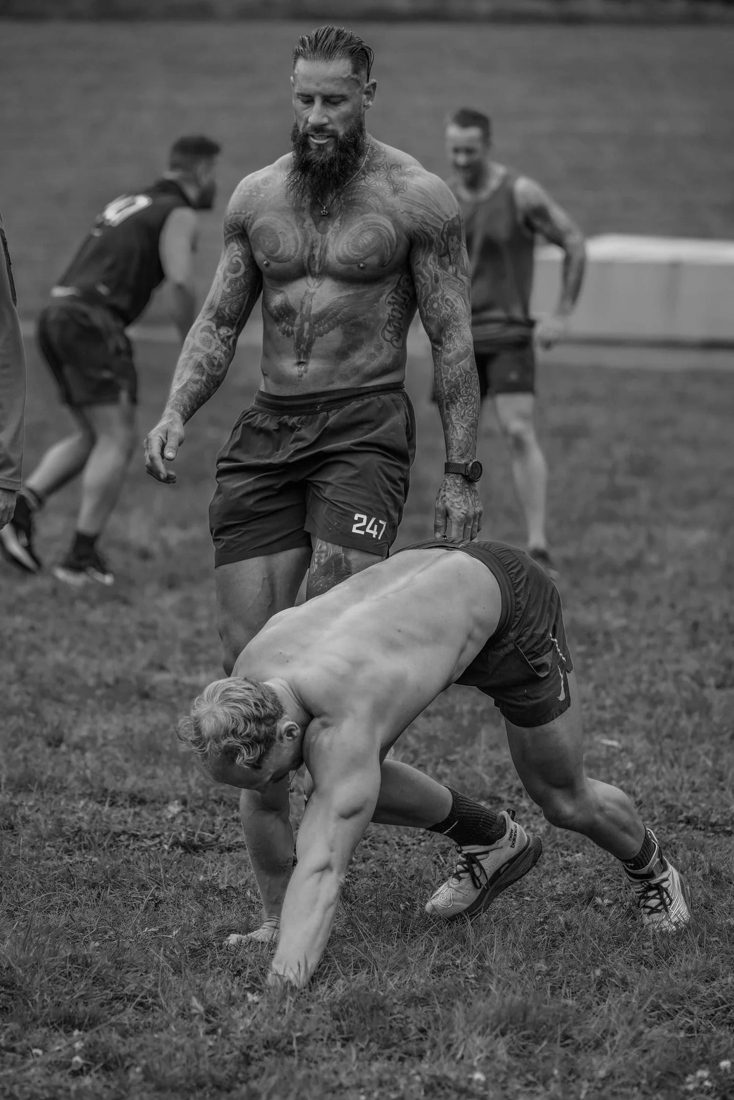 Atleet die op handen en voeten over de 30 meter lange baan kruipt tijdens de Bear Crawl Labour